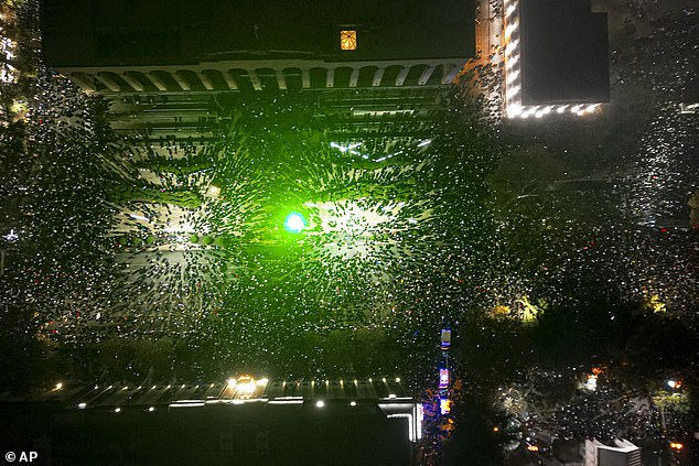 Protesters gather outside the Parliament building, center left, to protest against the government's decision to suspend negotiations on accession to the European Union for four years in Tbilisi, Georgia, on Saturday, November 30, 2024