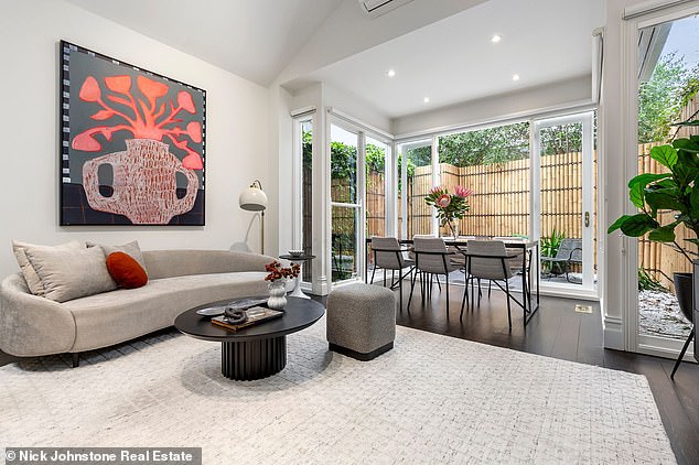 Another striking feature is the modernized kitchen and patio doors leading to a private courtyard