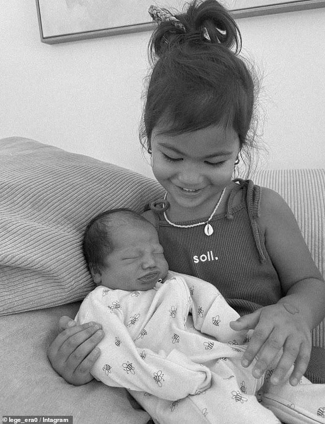 Haas took to Instagram to confirm the news, posting a photo of the newborn being cuddled by his older sister Lala, who is three (pictured)