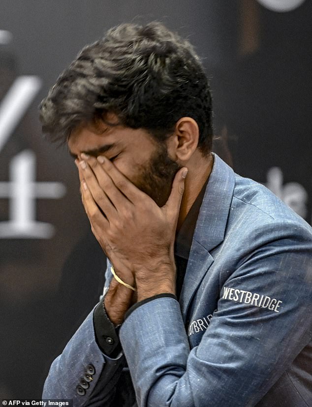 India's grandmaster Gukesh Dommaraju reacts after his victory over Chinese grandmaster Ding Liren