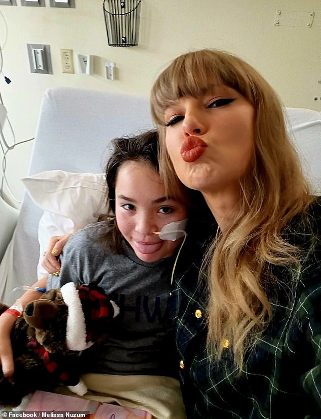 Taylor gave Baylee a signed copy of her Eras Tour book and accepted a gift from the little girl, a diamond art photo