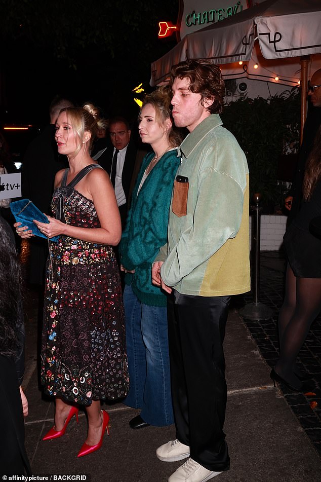 For the night out, Lukas wore a light green multi-print jacket and black trousers - and was later photographed with the two unidentified girls as he happily watched the event.