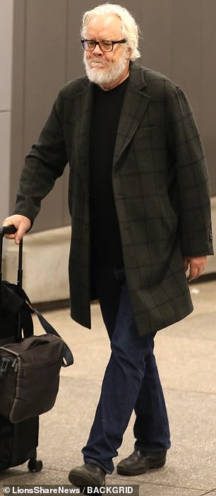 The actor in question is The Shawshank Redemption star Tim Robbins, who was spotted this week carrying a carry-on through Los Angeles International Airport.