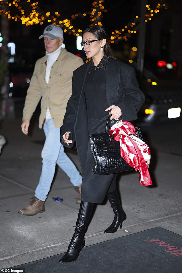 The beauty added height to her body with a pair of black boots and dressed warmly for the outing in a matching coat