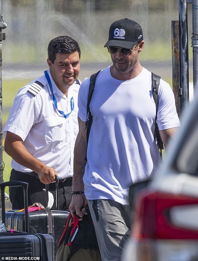 Chris kept a low profile, shielding his eyes from the bright sun with aviator glasses and wearing a black baseball cap.