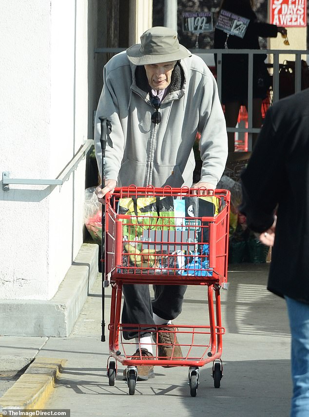 He protected his head with a green bucket hat and wore dark sunglasses