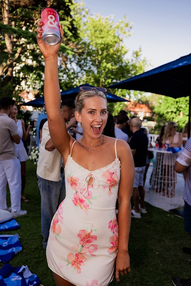 Stella Hutcheon looked radiant in a flirty white mini dress adorned with vibrant pink floral prints