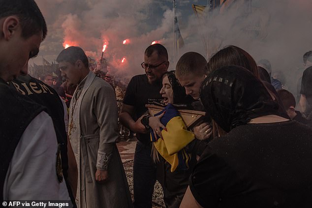 A woman reacts during her son's funeral at a cemetery in Vinnytsia. Nazary Gryntsevych, a Ukrainian soldier of the Azov Brigade, was one of the youngest soldiers who occupied the Azovstal steel plant in Mariupol during the Russian siege