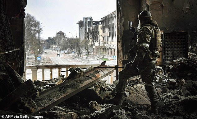 A Russian soldier patrols the Mariupol Drama Theater in April 2022