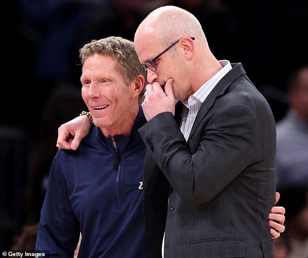 Few and Hurley talk on the court at Madison Square Garden before the game starts