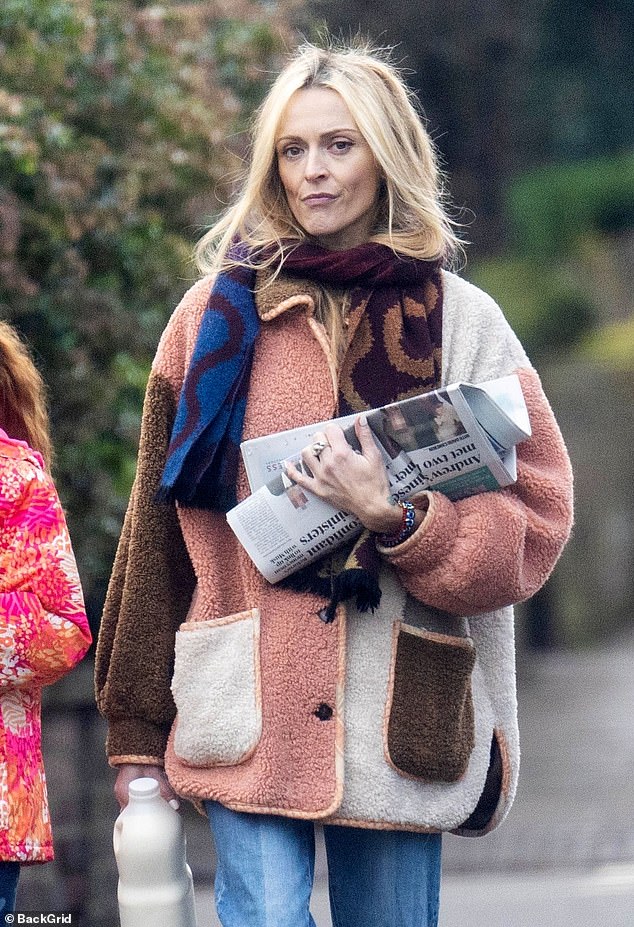 During the outing, the radio star was spotted without her wedding ring as she carried her purchases while wrapped in a teddy brown and pink coat and a blue scarf.