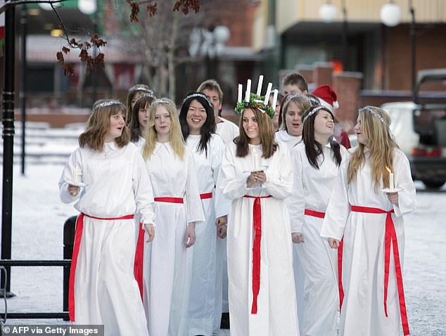 Saint Lucy brought food to Christians hiding in the Roman catacombs and used a candle-lit wreath on her head to light her way. Girls dress like the saint to honor her during the holiday