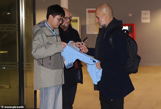 The Man City boss stopped to sign a fan's shirt despite the miserable result hours earlier