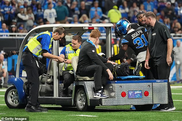 Dorsey is loaded onto a cart while his right leg is visible in an air cushion at Ford Field in Detroit