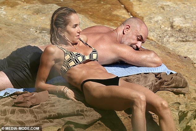 Edwards showed off her toned abs as she stretched her body over Clapp's back