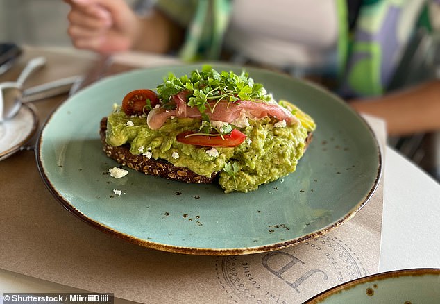 The 'Smashed Avo' comes with two poached eggs, crumbled feta, pumpkin hummus, melody tomatoes, roasted seed mix, lightly toasted sourdough bread and a slice of lemon (stock image)