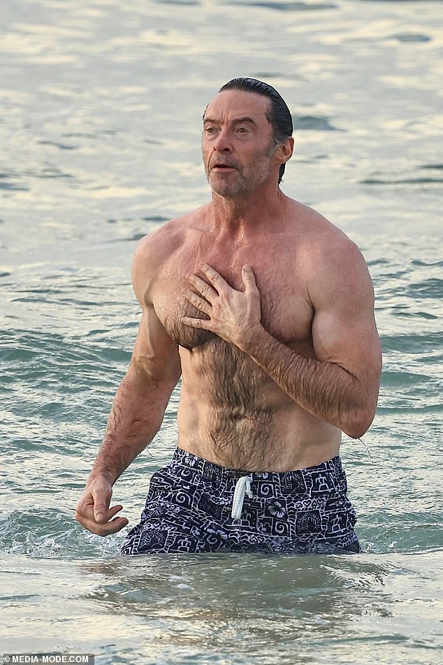 Hugh took a shirtless dip in the water and revealed his biceps as he went for a swim after enjoying a gym session with a friend