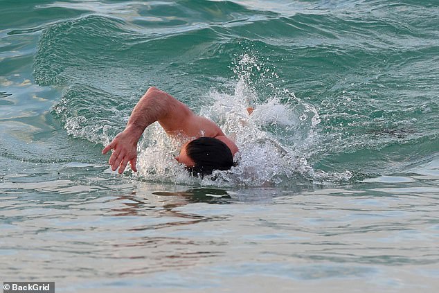 Hugh showed off his rippling abs and arms as he went for a swim