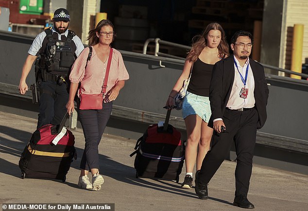 Tanya Sandoe, 56, and her 19-year-old daughter Georgia Sandoe-Simpson left the terminal via a side exit, escorted by Australian Federal Police officers