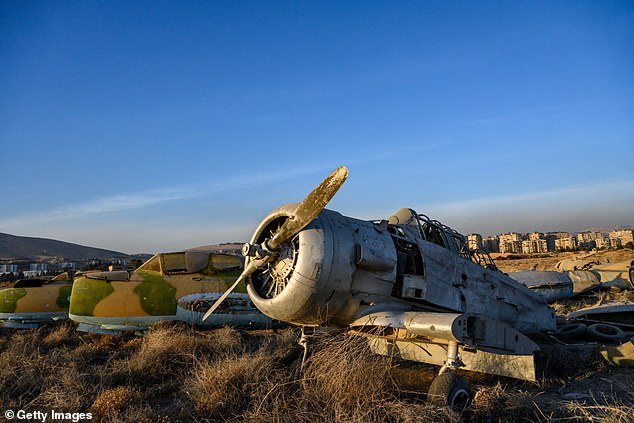 Discarded old Syrian Air Force planes are left next to the tarmac at Mezzeh military airport, as Israel carries out more than 500 Israeli strikes on military targets across Syria since the fall of the Assad regime, on December 15, 2024 in Damascus, Syria