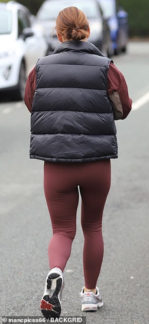 Coleen showed off her stunning physique in plum leggings and a black padded jacket