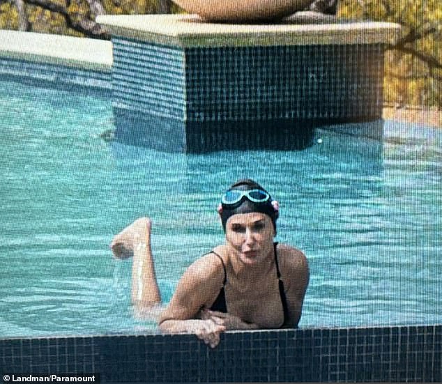 Moore made a splash as she modeled a black swimsuit while sitting in her pool at her mega-mansion in Texas