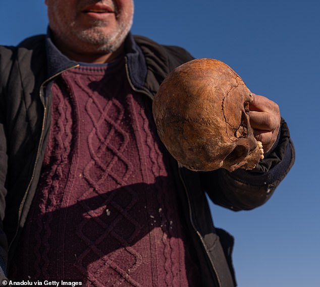 The remains of bodies believed to be those of civilians killed by Bashar al-Assad's regime are being exhumed from a mass grave near the Baghdad Bridge outside the Syrian capital.