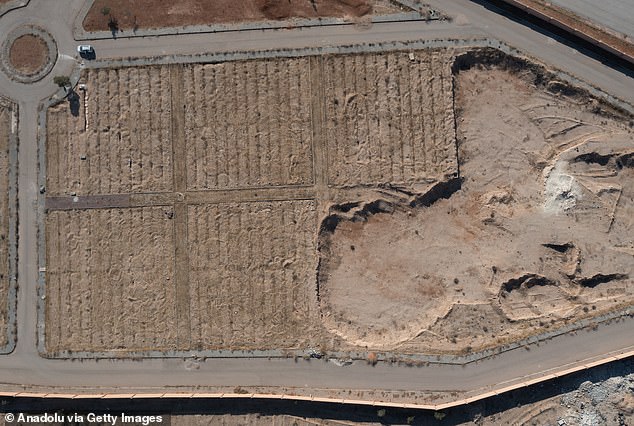 An aerial view of the mass grave as teams work to exhume the bodies of civilians