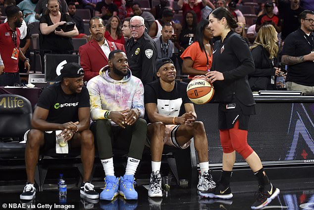 James (seen between Chris Paul and Russell Westbrook) is a longtime WNBA fan. In this shot from 2019, he and his fellow All-Stars watch Kelsey Plum (right) and the Aces