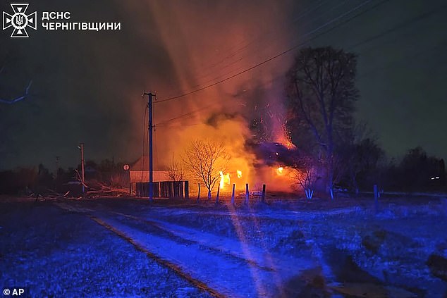 Burning buildings are seen at the scene after a Russian drone strike in the Chernihiv region, Ukraine, early Friday, December 13, 2024