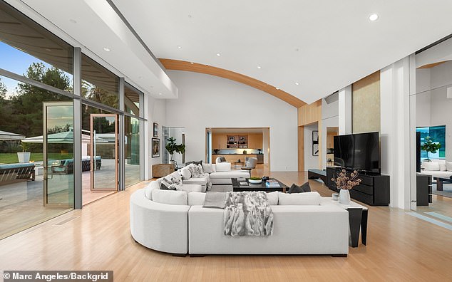 The living room features a large cream-colored sofa