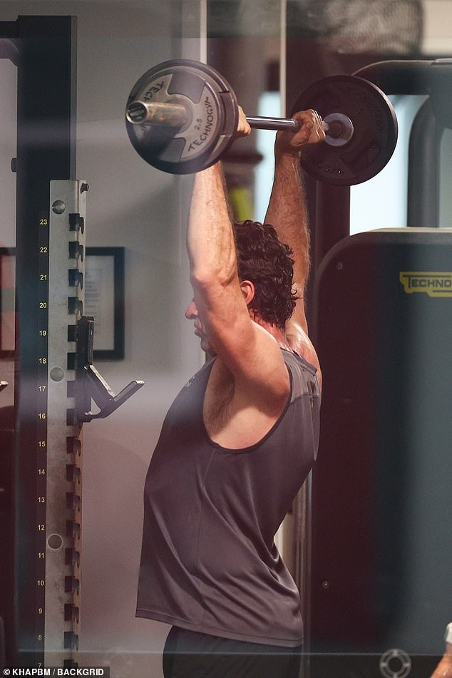 He was seen working up a sweat as he lifted a weighted barbell and worked the muscles of his upper body