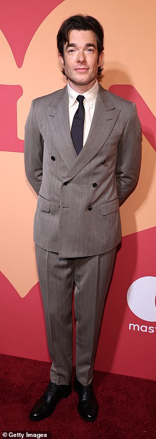 Mulaney complemented his wife in a light gray double-breasted suit and cream shirt