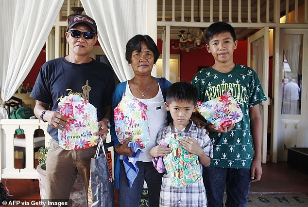 The Veloso family, including her two young sons