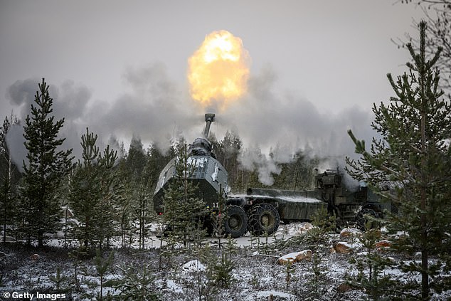 A Swedish artillery team fires a projectile from an Archer self-propelled howitzer during NATO "Lightning strike exercise" on November 20