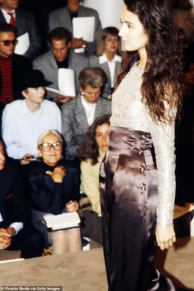 Mellen watches from the front row as model Gail Elliott walks the catwalk in the 1990s