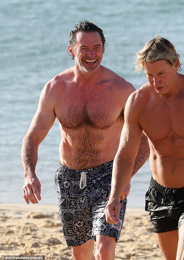 During his latest beach outing, Hugh seemed to be in a jovial mood as he caught up with his good friend and trainer Michael.