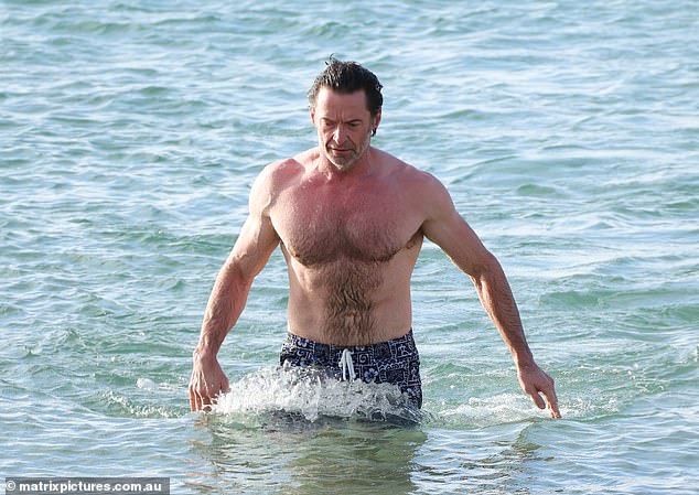 Hugh cooled off with a dip in the sea as he made the most of his time in his native Australia over the festive period