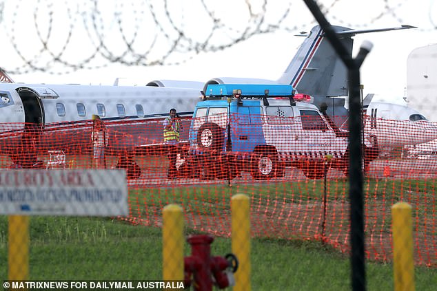 The ambulance, along with a retinue of cars, stopped at a side security gate that led straight to the tarmac