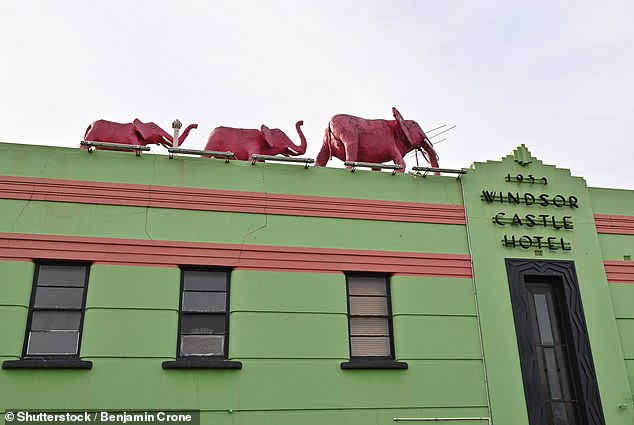 The Windsor Castle Hotel has three striking pink elephants on its roof (pictured)