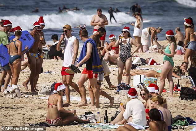 Fortunately, Aussies will get a brief reprieve from the sweltering heatwaves of recent weeks (photo: Christmas revelers at Bondi Beach in 2022)