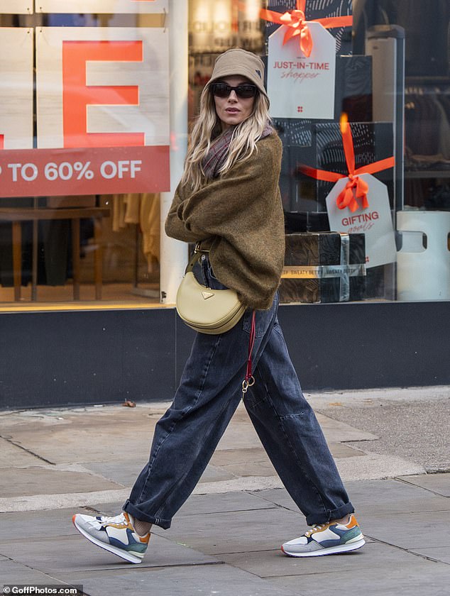 The actress looked incredibly stylish in a khaki Adidas bucket hat and light green Prada crossbody bag