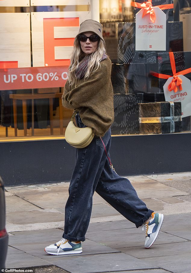 The model and actress wrapped themselves warmly in her stylish sweater