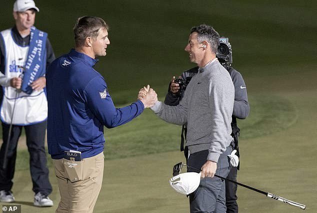 DeChambeau shakes hands with McIlroy after the highlight of the event at Shadow Creek