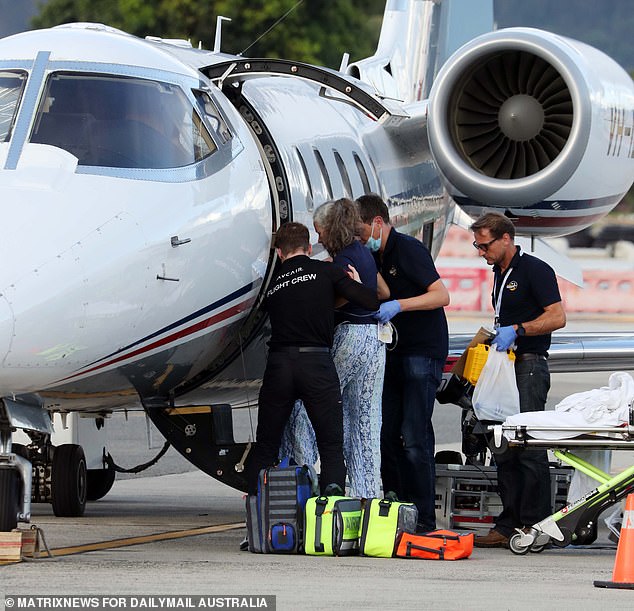 The woman was helped up and down the plane's stairs on either side of her journey on Wednesday