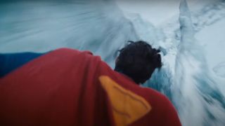 A close-up of Superman flying over an icy location in James Gunn's Superman movie