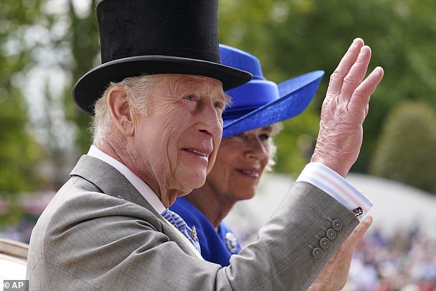 King Charles III and Queen Camilla wave as they arrive by carriage on the first day of the Royal Ascot horse race in Ascot