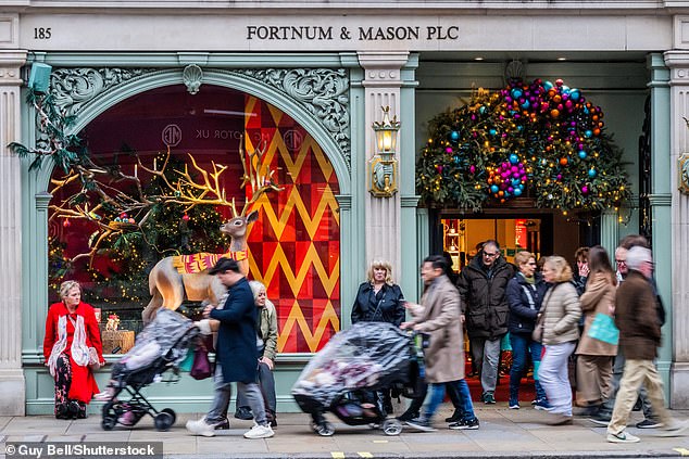 Fortnum & Mason in Piccadilly, busy with shoppers enjoying their festive window displays