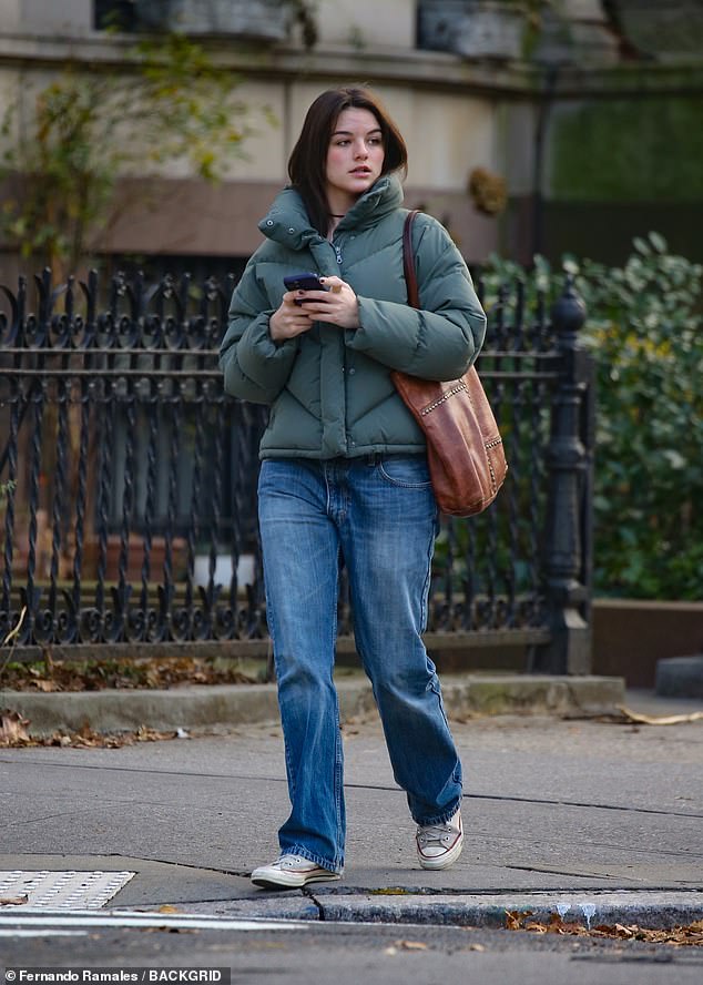 The nepo baby wore relaxed straight-fit jeans with gray sneakers and carried a brown leather studded tote bag