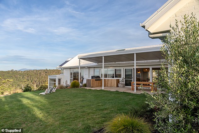 The L-shaped house has a private, lush backyard